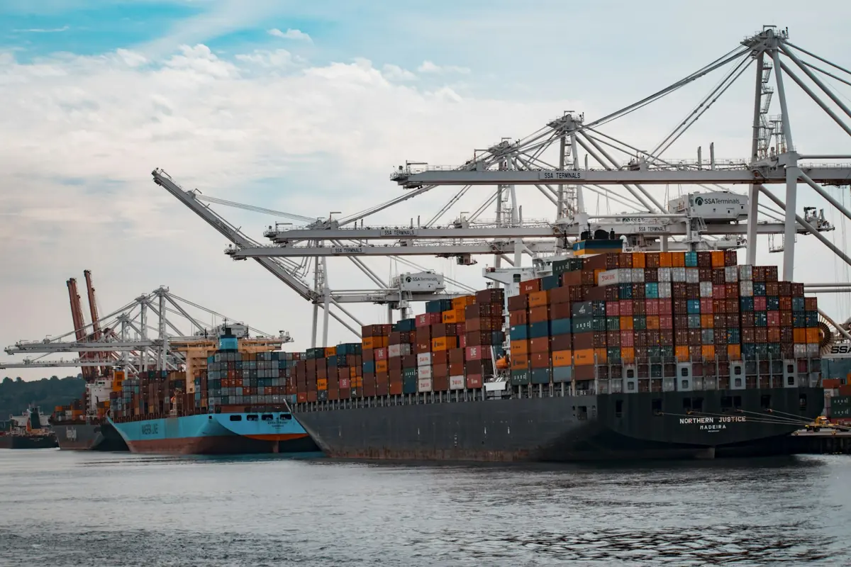 A container ship being loaded by port cranes
